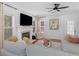 Comfortable living room features fireplace, large TV, and inviting seating at 144 Wyckliffe Dr, Locust Grove, GA 30248