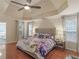 Spacious main bedroom featuring a tray ceiling, ceiling fan, and hardwood floors at 144 Wyckliffe Dr, Locust Grove, GA 30248