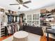 Spacious walk-in closet featuring custom shelving, soft rug and storage for clothing, accessories, and designer handbags at 144 Wyckliffe Dr, Locust Grove, GA 30248