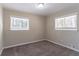 Bedroom featuring neutral carpet, two windows and a ceiling light at 2202 Polar Rock Sw Pl, Atlanta, GA 30315