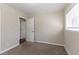 Bedroom featuring neutral carpet and vertical paneling with an open door to another room at 2202 Polar Rock Sw Pl, Atlanta, GA 30315