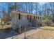Grey brick home with a red door featuring a fenced yard and concrete walk and driveway at 2202 Polar Rock Sw Pl, Atlanta, GA 30315