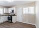 Bright kitchen with stainless steel appliances, white cabinetry, and wood flooring at 2202 Polar Rock Sw Pl, Atlanta, GA 30315