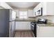 Modern kitchen with stainless steel appliances, white cabinetry, and granite countertops at 2202 Polar Rock Sw Pl, Atlanta, GA 30315