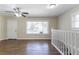 Bright living room featuring hardwood floors, a ceiling fan, white trim, and a large window at 2202 Polar Rock Sw Pl, Atlanta, GA 30315