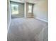Cozy bedroom featuring carpet flooring and ample natural light from two windows at 2407 Malster Ln, Lawrenceville, GA 30043