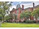 Historic brick building featuring a clock tower, arched windows, and green lawn at 2407 Malster Ln, Lawrenceville, GA 30043