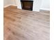 Close-up on a modern fireplace with LVP flooring in a living room at 2407 Malster Ln, Lawrenceville, GA 30043
