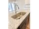 Close up on a kitchen sink with a stainless steel faucet and granite countertop at 2407 Malster Ln, Lawrenceville, GA 30043