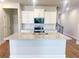 Kitchen island with granite countertops, modern appliances, and white cabinets at 2407 Malster Ln, Lawrenceville, GA 30043