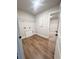 A spacious laundry room offering hardwood floors, wire shelving, and natural light at 2407 Malster Ln, Lawrenceville, GA 30043