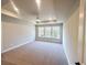 Spacious main bedroom with a tray ceiling, carpet flooring, and bright natural light at 2407 Malster Ln, Lawrenceville, GA 30043