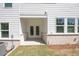Covered patio with white painted brick base and a pair of glass doors at 2407 Malster Ln, Lawrenceville, GA 30043