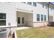 Rear view of patio with painted brick base and double glass doors at 2407 Malster Ln, Lawrenceville, GA 30043