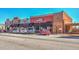 Street view of a row of storefronts with cars parked along the street on a clear, sunny day at 2407 Malster Ln, Lawrenceville, GA 30043