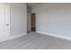 Bedroom with neutral paint and carpet features a door with white trim, continuing the color scheme at 76 Lakeview Pt, Dallas, GA 30157