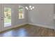 Bright dining area with hardwood floors, white trim, and a modern chandelier at 76 Lakeview Pt, Dallas, GA 30157