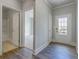 Bright entryway featuring hardwood floors, white trim, and doorways leading to various rooms at 76 Lakeview Pt, Dallas, GA 30157