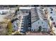 Aerial view showcasing townhomes adjacent to a fenced dog park, with convenient parking and proximity to local amenities at 122 Brighton Blvd, Woodstock, GA 30188