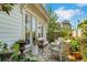 Charming back patio with wicker seating, potted plants, and string lights, perfect for relaxing outdoors at 122 Brighton Blvd, Woodstock, GA 30188