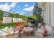 Stylish back patio with multiple seating areas, string lights, and lush landscaping, creating an inviting outdoor space at 122 Brighton Blvd, Woodstock, GA 30188