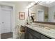 Stylish bathroom featuring a granite countertop, decorative accents, and a well-lit mirror with a white framed door at 122 Brighton Blvd, Woodstock, GA 30188