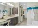 Bathroom featuring dark cabinetry, modern countertops, and stylish herringbone tile flooring at 122 Brighton Blvd, Woodstock, GA 30188