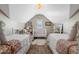 Shared bedroom featuring two twin beds, neutral decor, and a cozy atmosphere with carpet and tile flooring at 122 Brighton Blvd, Woodstock, GA 30188