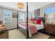 Bedroom boasts a four-poster bed, neutral tones, and natural light from shuttered windows at 122 Brighton Blvd, Woodstock, GA 30188