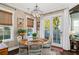 Cozy dining area with rustic decor and views to the exterior patio creates a warm and inviting atmosphere at 122 Brighton Blvd, Woodstock, GA 30188