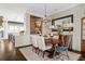 Dining room featuring a stylish chandelier, dark hardwood floors, and natural light at 122 Brighton Blvd, Woodstock, GA 30188