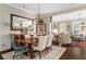 Open-concept dining room with hardwood floors and views into the formal living room at 122 Brighton Blvd, Woodstock, GA 30188