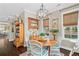 Bright dining room with white chairs, wood table, and natural light from surrounding windows creates a welcoming space at 122 Brighton Blvd, Woodstock, GA 30188