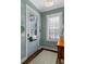 Charming entryway featuring patterned wallpaper, a blue door, and lots of natural light at 122 Brighton Blvd, Woodstock, GA 30188