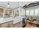 An expansive kitchen flows into the living area, with white countertops and stainless appliances, great for gatherings at 122 Brighton Blvd, Woodstock, GA 30188