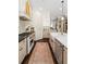 Bright kitchen with modern appliances, herringbone backsplash, and elegant cabinetry provides ample storage and counter space at 122 Brighton Blvd, Woodstock, GA 30188