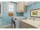 Functional laundry room with modern washer and dryer, a sink, cabinetry, and stylish decorations at 122 Brighton Blvd, Woodstock, GA 30188