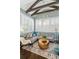 Inviting living room with stylish wallpaper, wooden ceiling beams, and ample natural light offers a cozy retreat at 122 Brighton Blvd, Woodstock, GA 30188