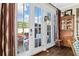 Inviting sunroom with French doors leading to a private outdoor patio and garden area at 122 Brighton Blvd, Woodstock, GA 30188