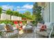 Relaxing outdoor patio with comfortable seating, decorative pillows, and a well-manicured garden at 122 Brighton Blvd, Woodstock, GA 30188