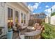 Serene patio setting featuring a cozy seating area, views of lush greenery, and string lights at 122 Brighton Blvd, Woodstock, GA 30188