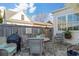 Inviting patio with wicker furniture, brick pavers, and a plant, perfect for relaxation at 122 Brighton Blvd, Woodstock, GA 30188