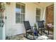 Relaxing porch setting with comfortable rocking chairs and a quaint outdoor rug at 122 Brighton Blvd, Woodstock, GA 30188