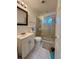Bathroom featuring tiled shower, white vanity, and tiled flooring at 172 Scarsdale Dr, Riverdale, GA 30274