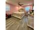 Bedroom featuring pink walls, a decorative headboard, and hardwood flooring at 172 Scarsdale Dr, Riverdale, GA 30274