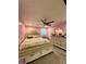 Bedroom featuring pink walls, decorative headboard, and hardwood flooring at 172 Scarsdale Dr, Riverdale, GA 30274