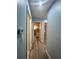 Hallway with wood floors that leads to bedrooms and a view of other rooms at 172 Scarsdale Dr, Riverdale, GA 30274
