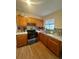 Well-equipped kitchen with granite counters, wood cabinets, and stainless steel appliances at 172 Scarsdale Dr, Riverdale, GA 30274