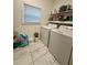 Laundry room featuring marble flooring, window and washer and dryer at 172 Scarsdale Dr, Riverdale, GA 30274