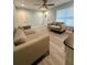 Bright living room featuring neutral paint, modern ceiling fan, and new wood floors at 172 Scarsdale Dr, Riverdale, GA 30274
